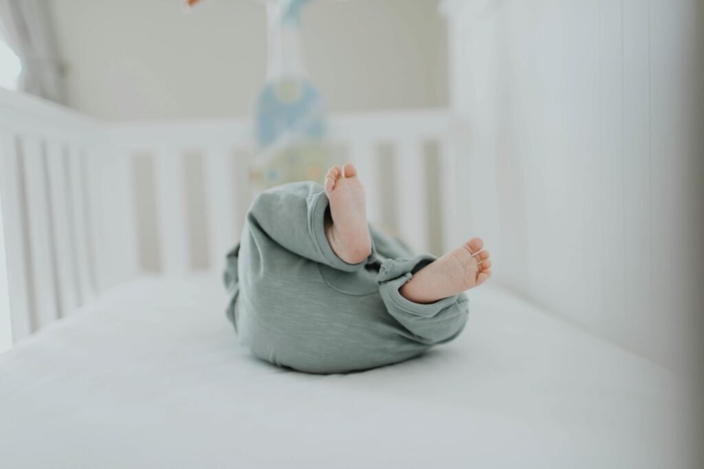 Close-up Photo of Baby Wearing Gray Pants